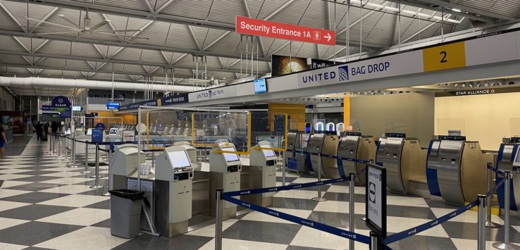 an airport check-in area with security gates