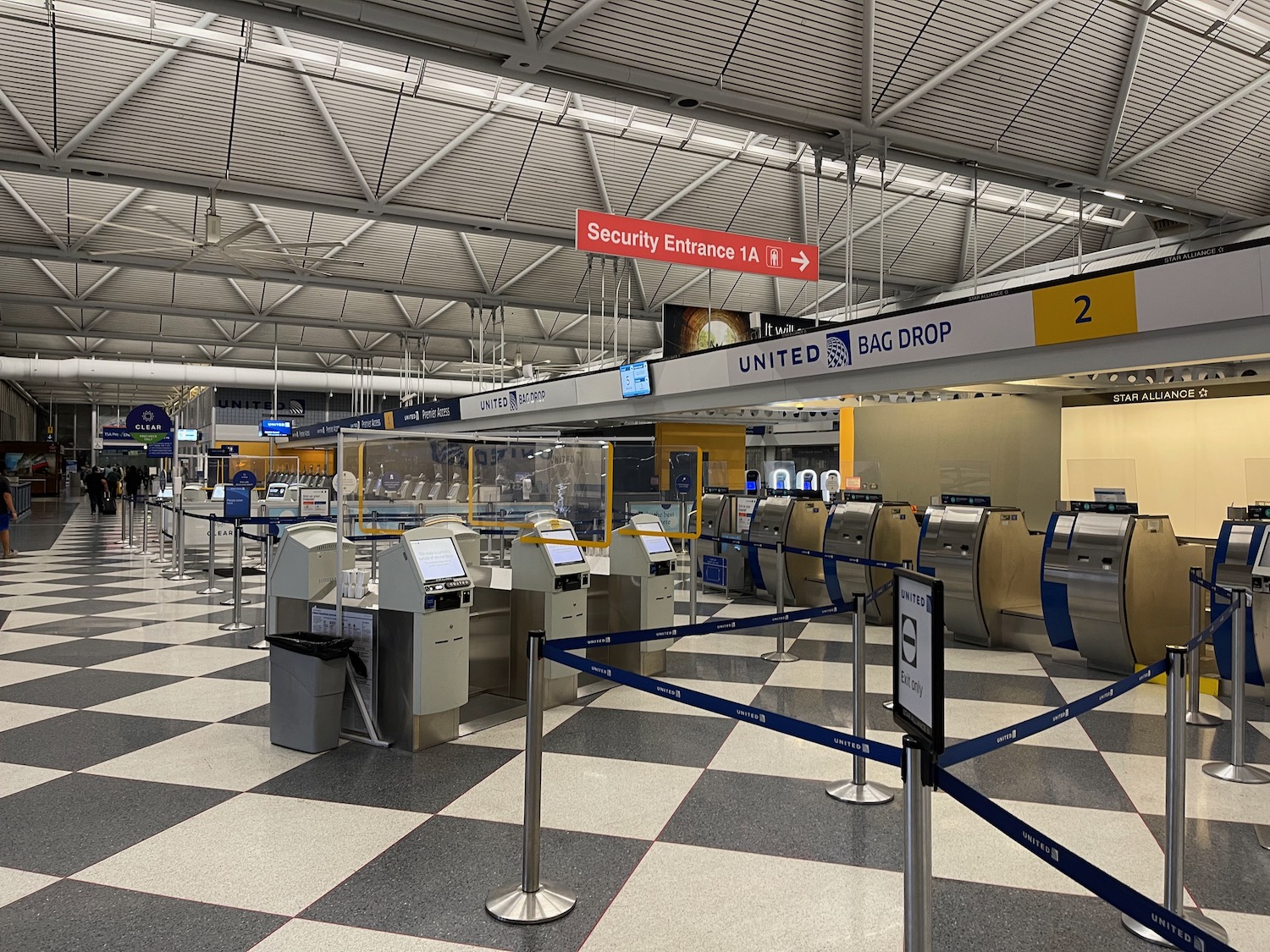 an airport check-in area with security gates