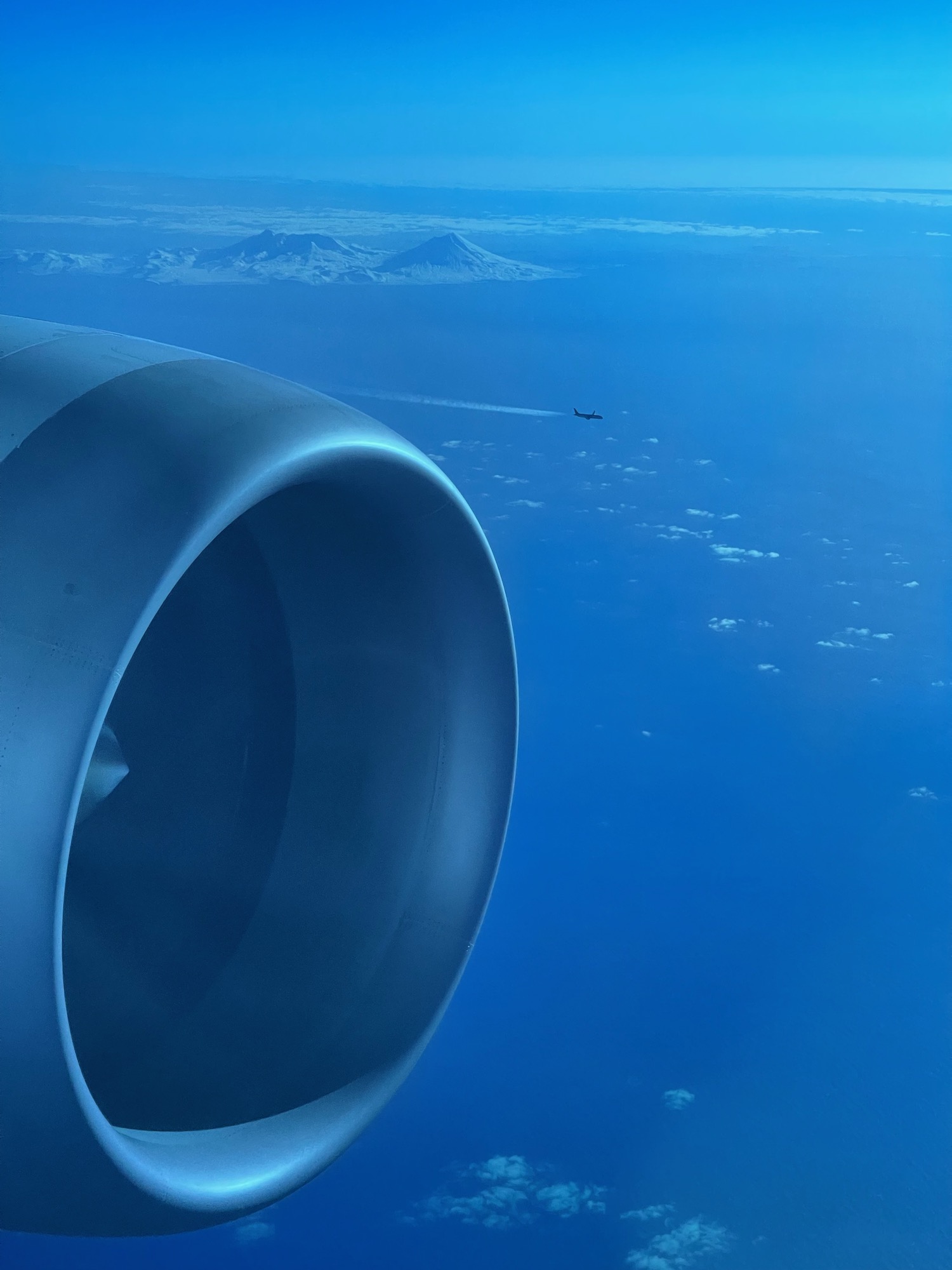 a jet engine and a mountain in the distance