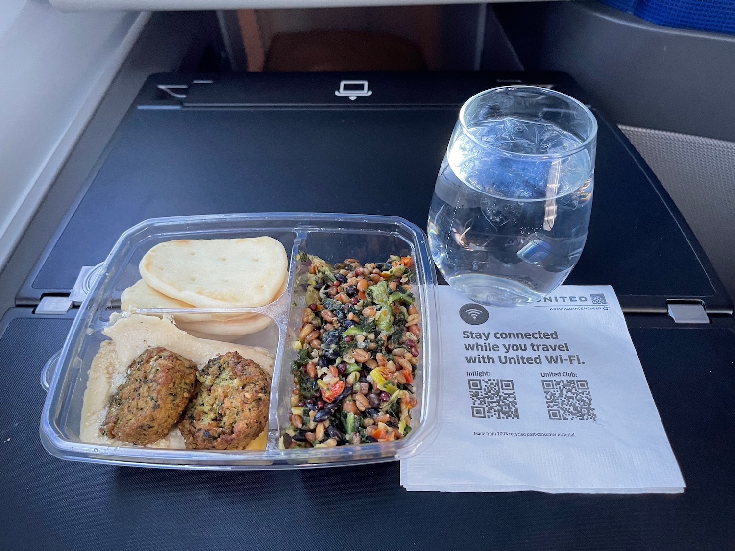 a tray of food and a glass of water