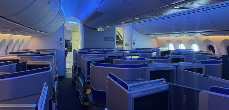 an airplane with a row of seats and a television