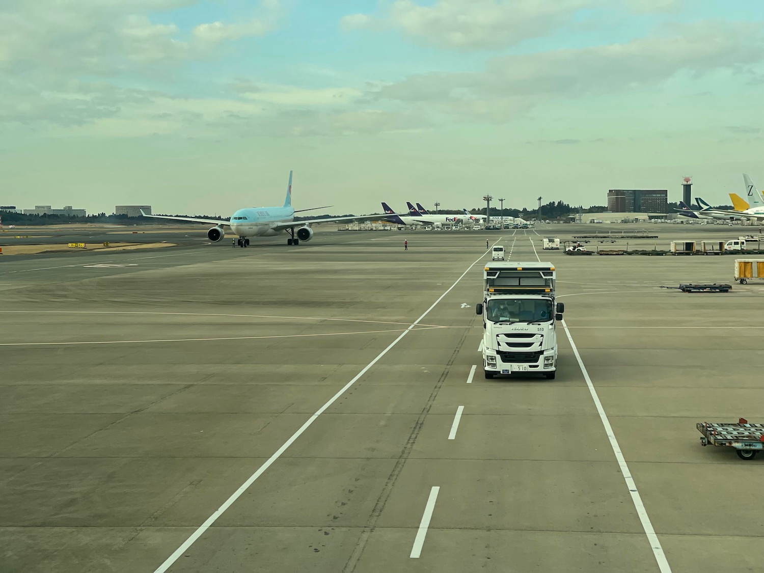 a white truck and a white truck on a runway