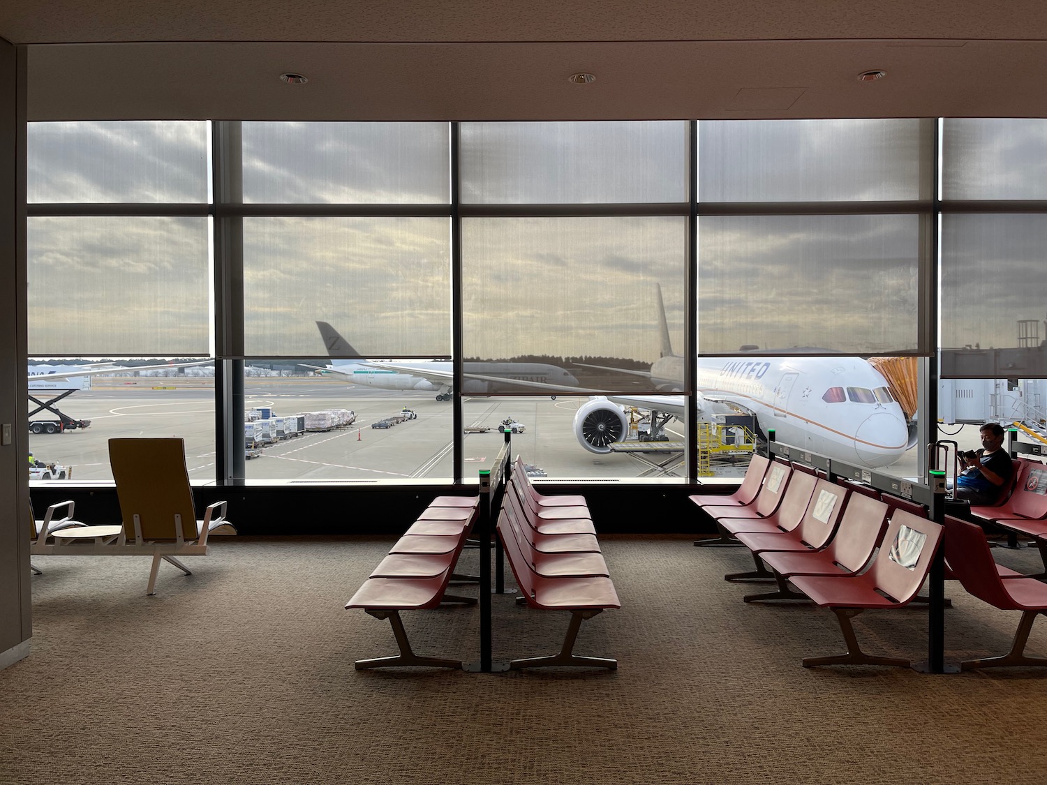 a room with chairs and a plane in the background
