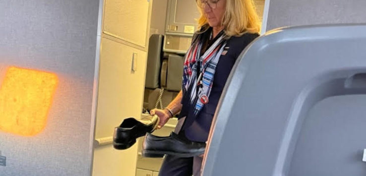 a woman holding shoes in an airplane