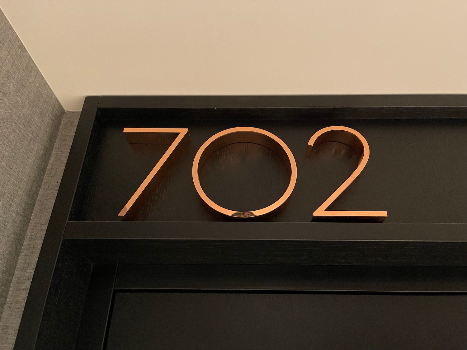a black door with gold numbers