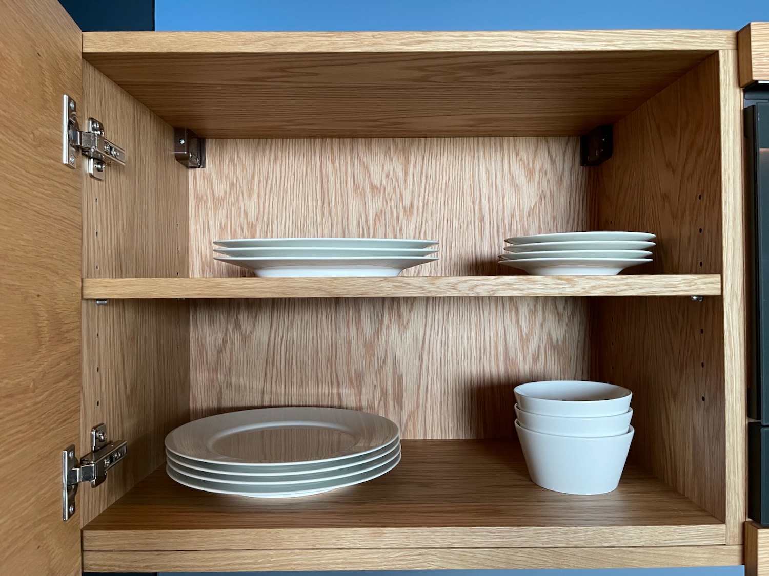 a wooden cabinet with plates and bowls