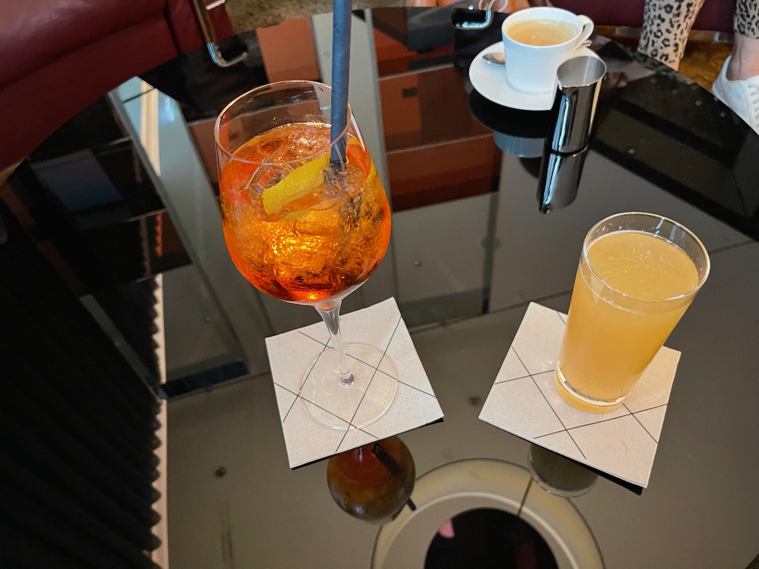 a glass of orange liquid and a glass of orange liquid on a table
