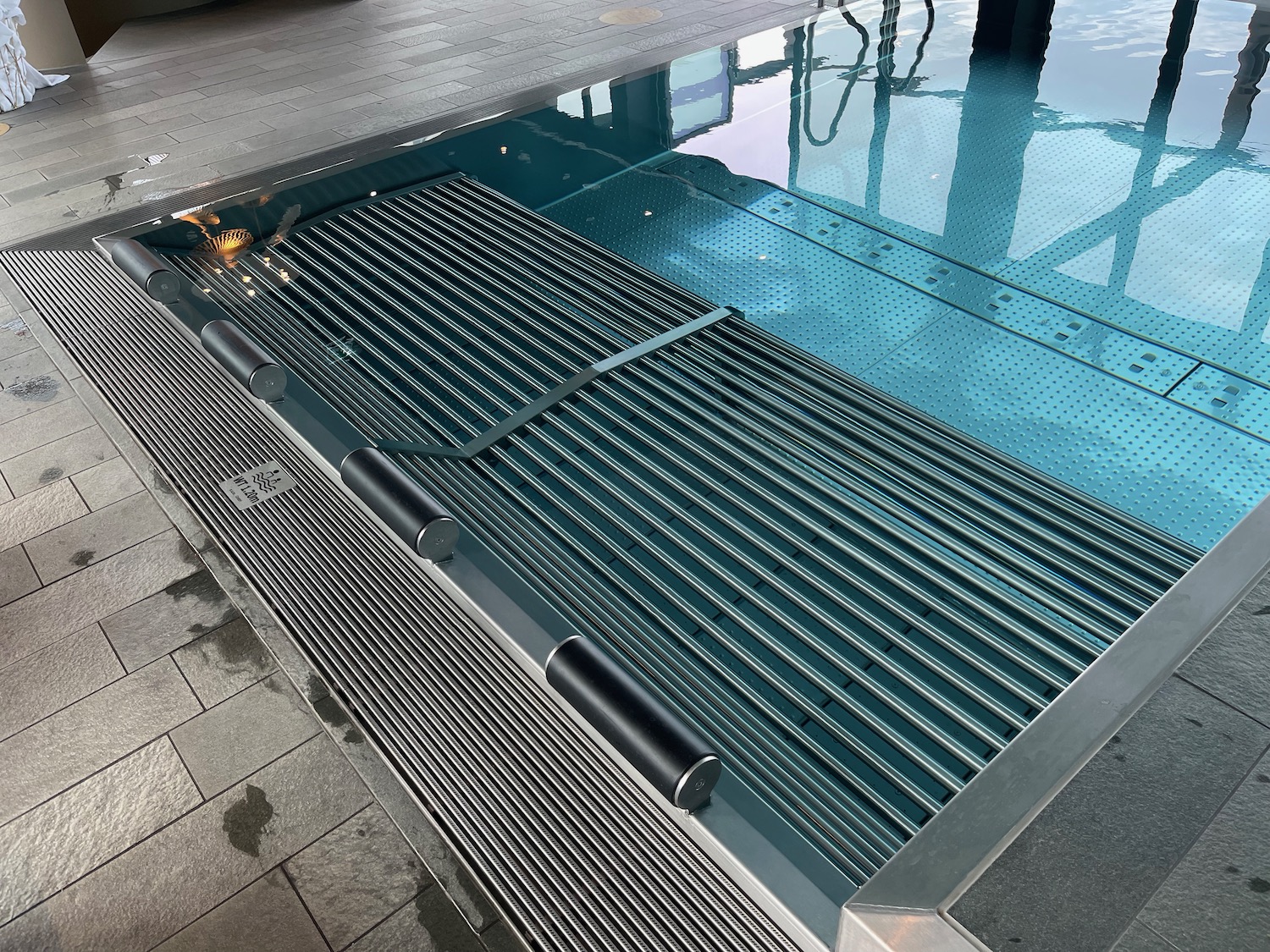 a pool with a metal grate