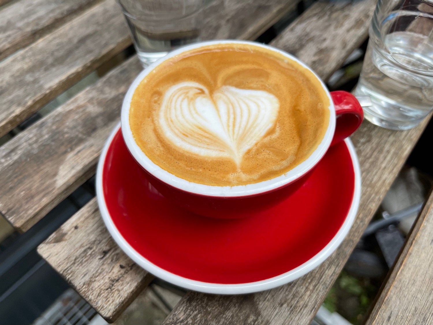 a cup of coffee with a heart shaped foam in it