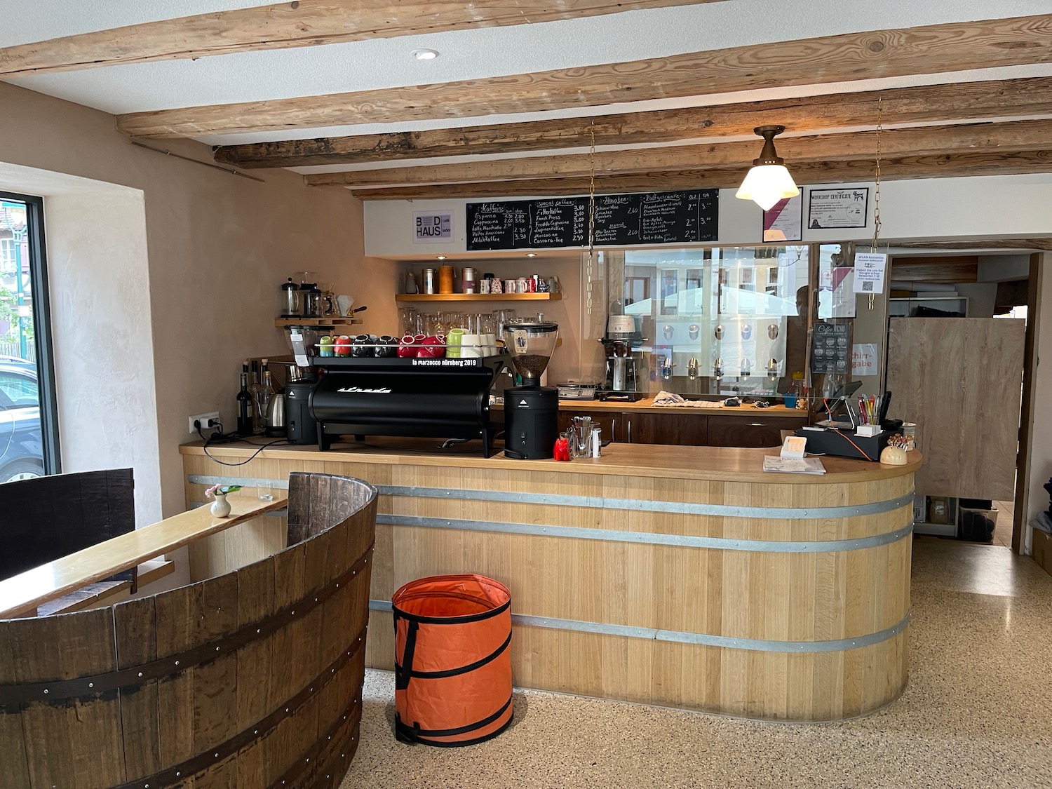 a coffee shop with a barrel and a counter