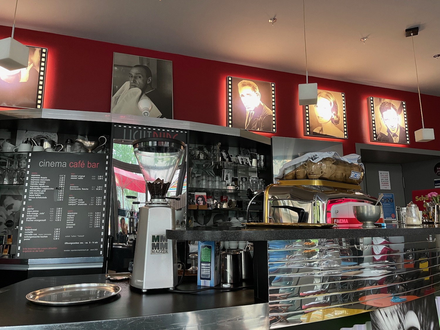 a counter with a coffee maker and a menu