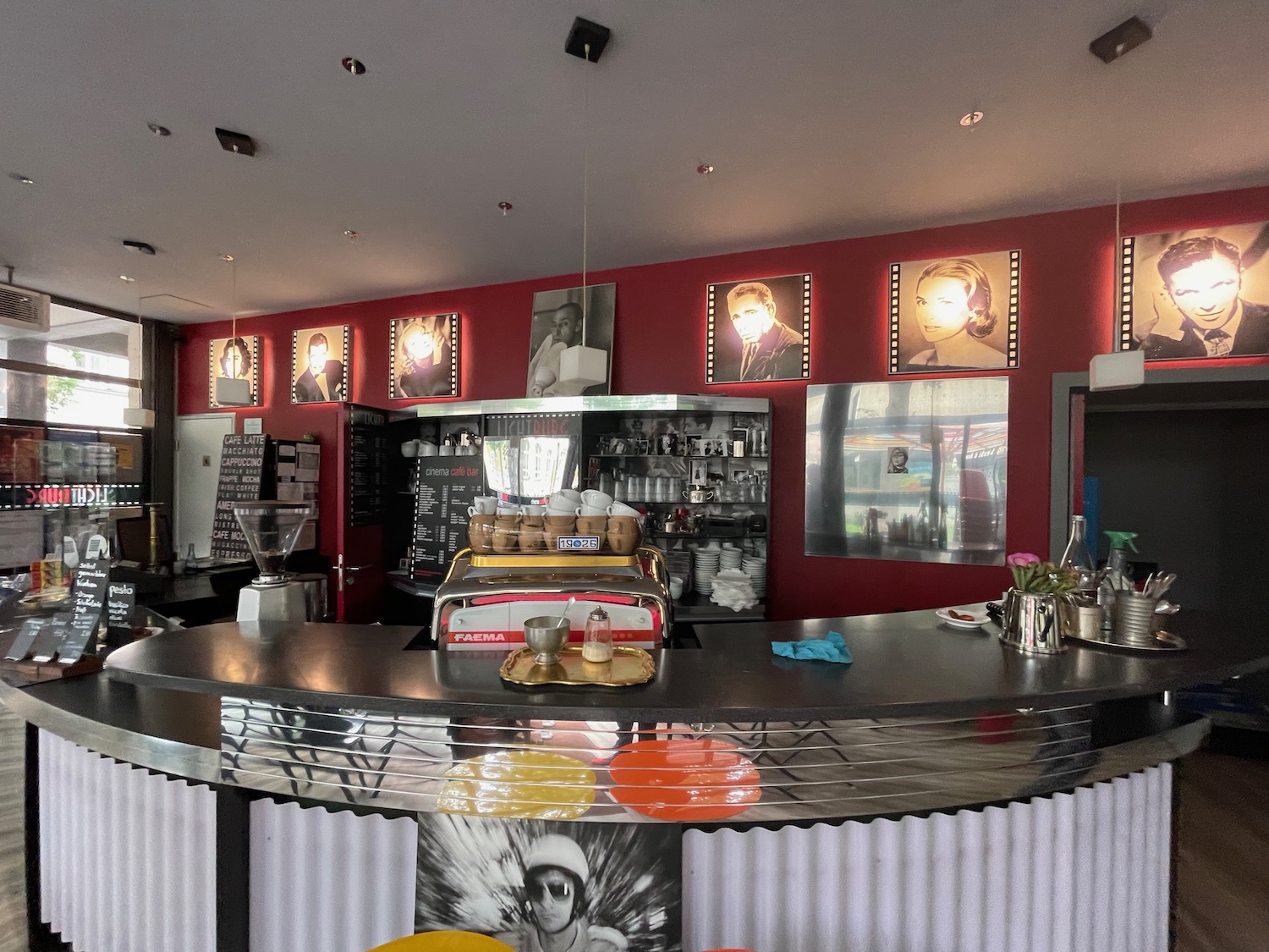 a bar with a counter and pictures on the wall