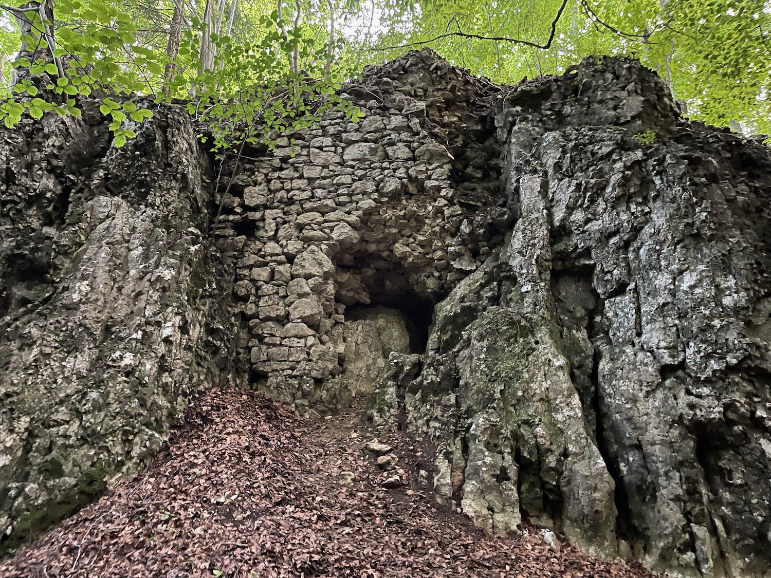 a rock wall with a hole in it