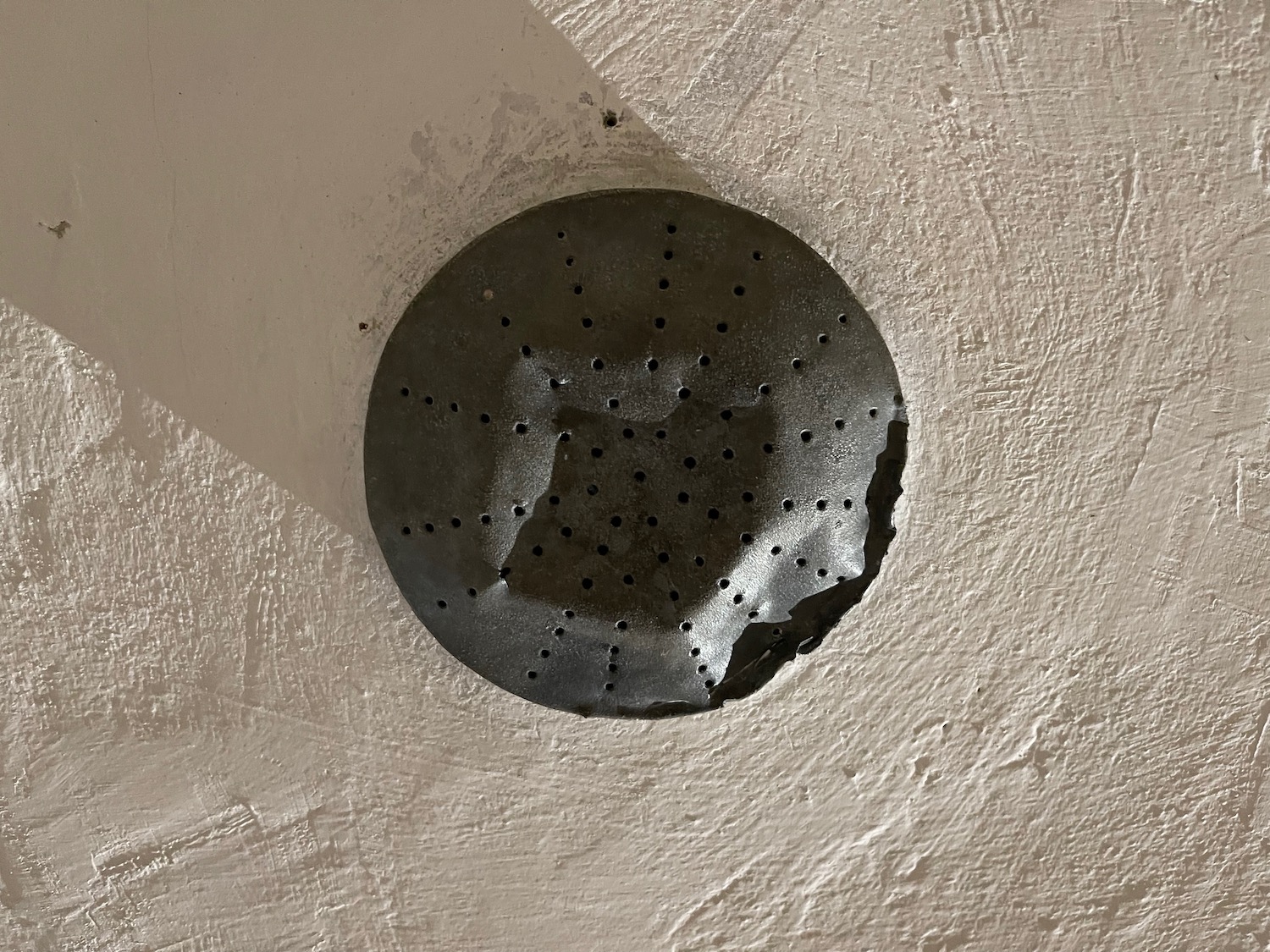 a black circle with holes on the wall