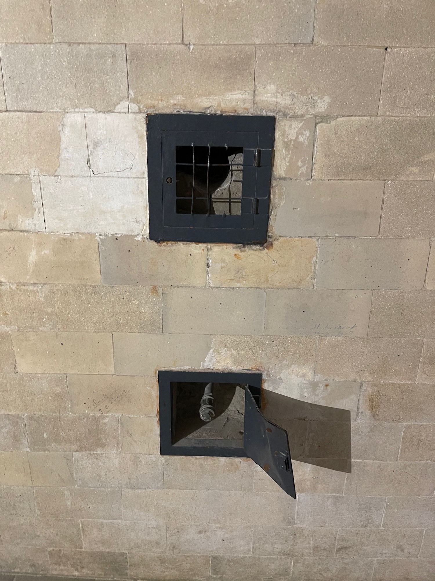 a two square windows on a stone wall