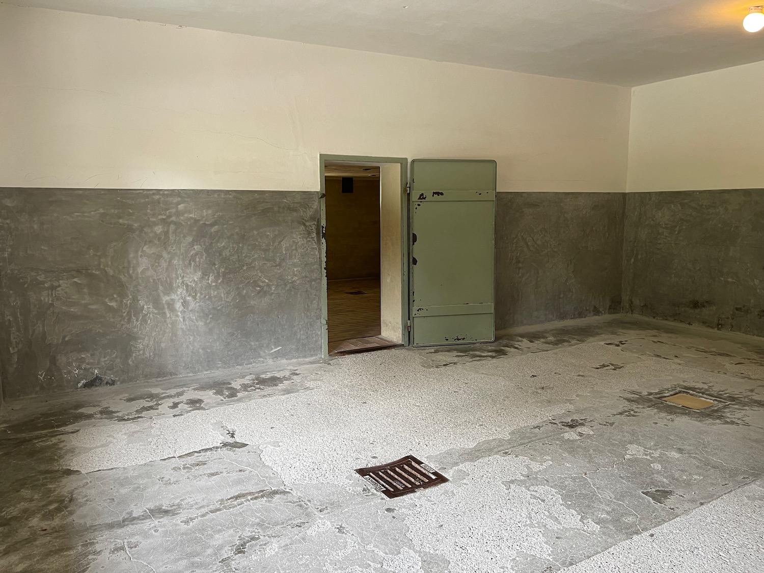 a room with a door open and concrete walls