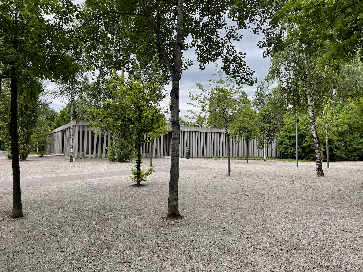 a building with trees and a stone wall