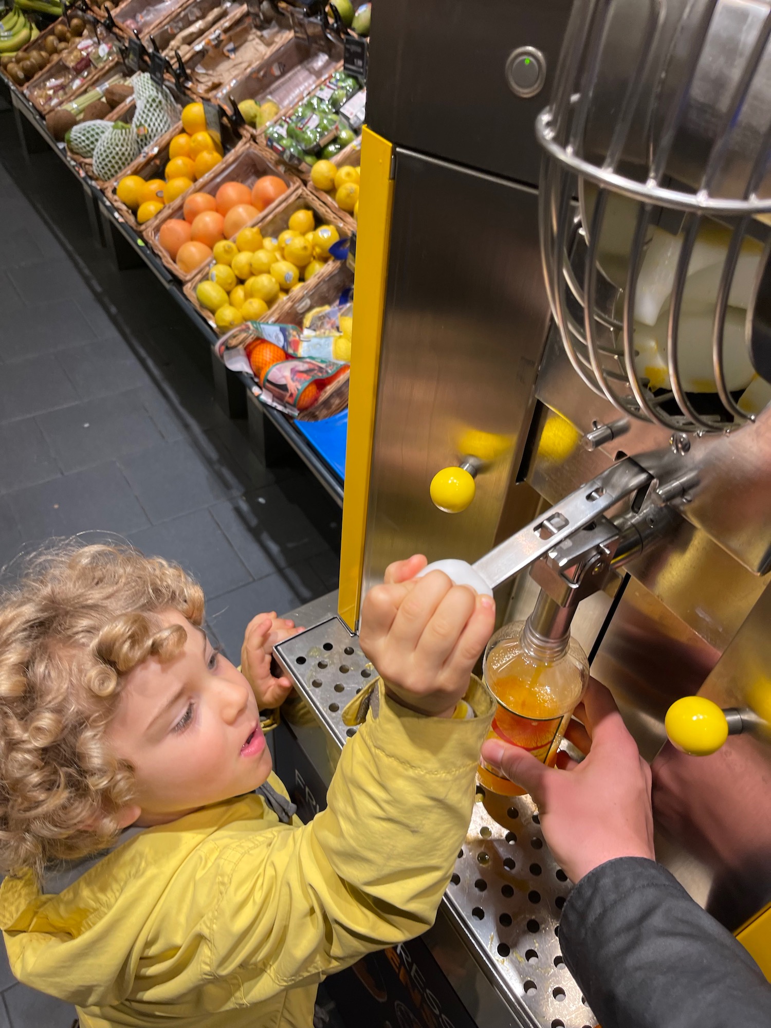 a child at a juice dispenser