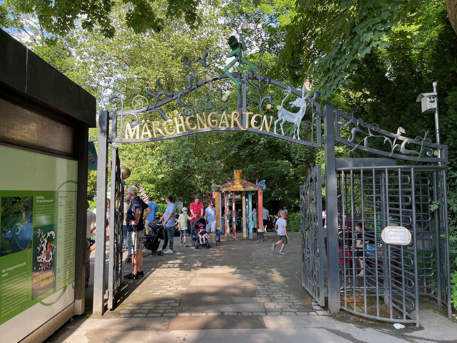 a gate with people walking around