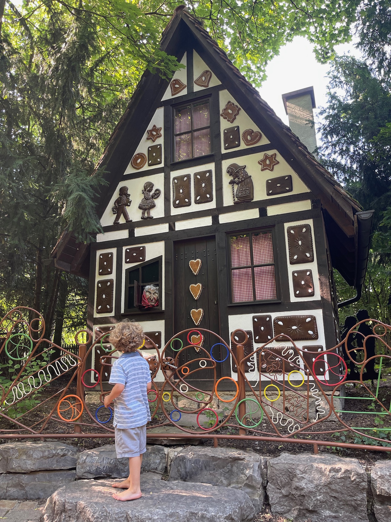 a child standing in front of a house