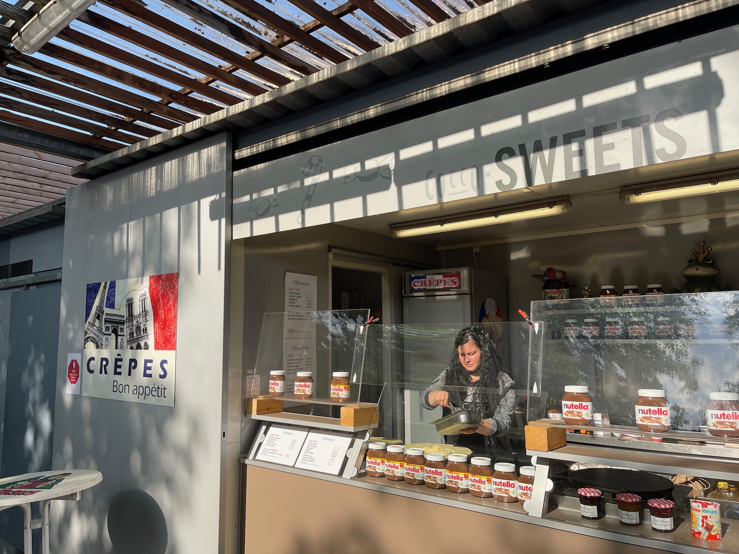 a woman selling food in a food cart