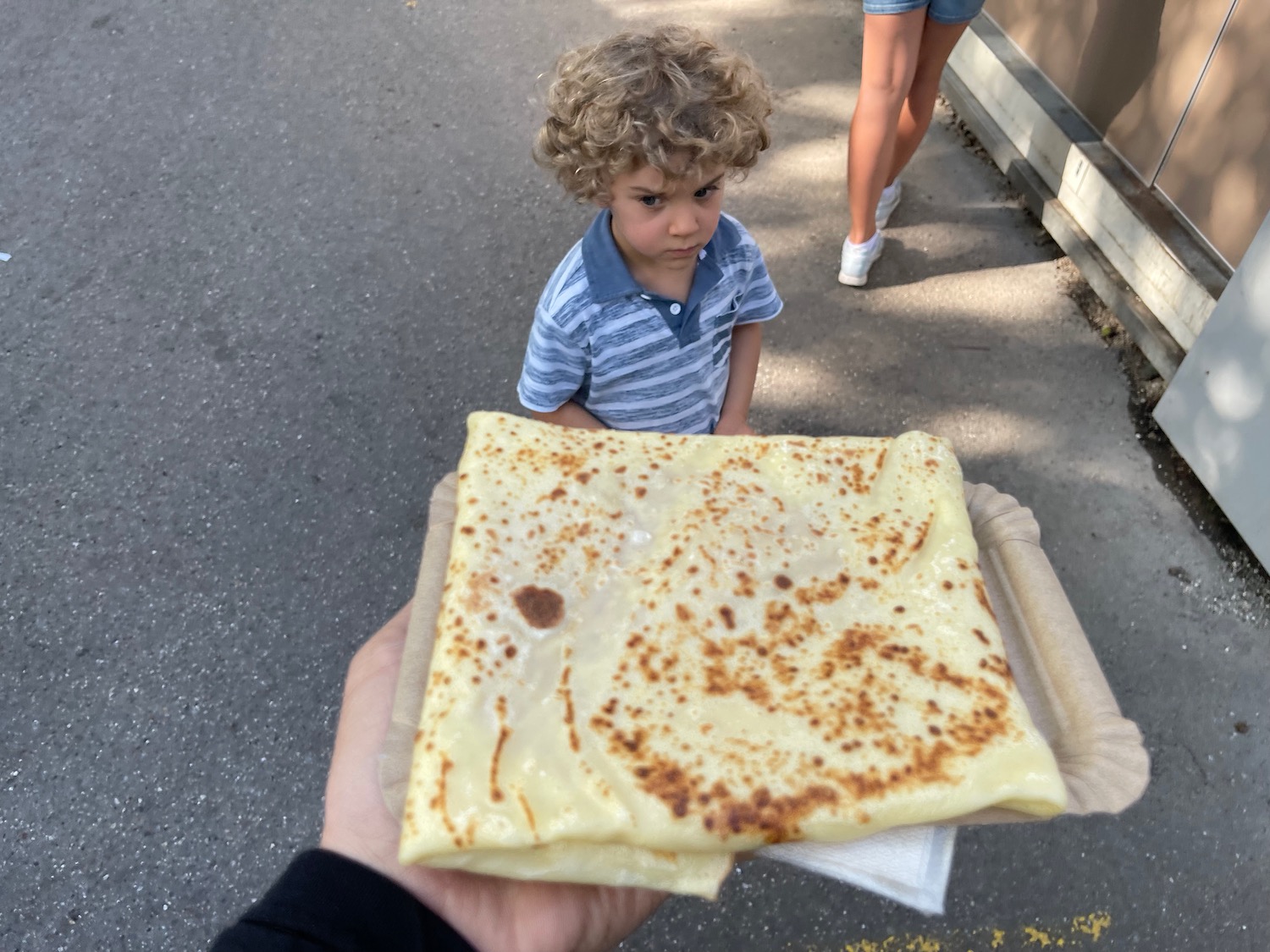 a child holding a crepe