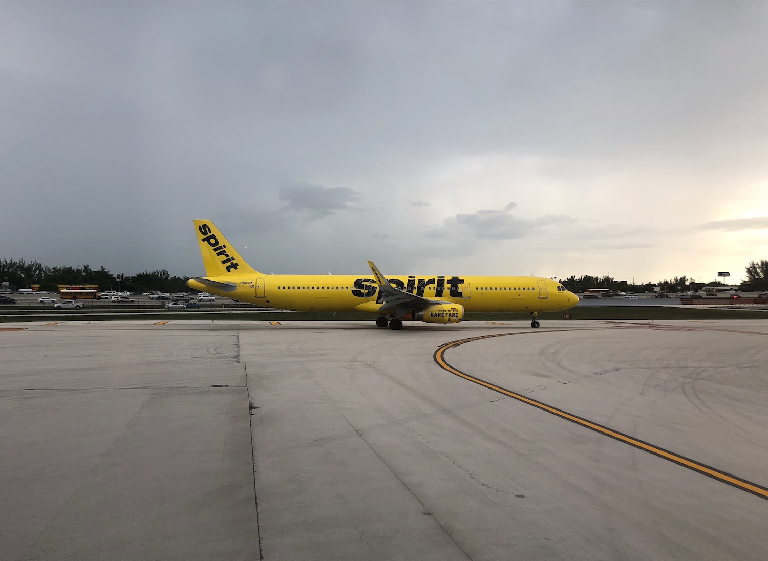 a yellow airplane on a runway