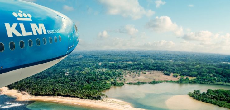 a plane flying over a beach