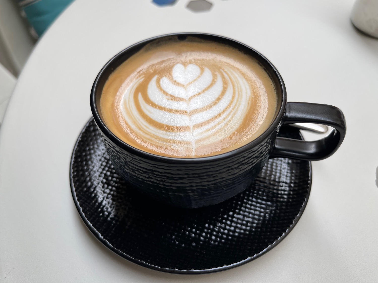 a cup of coffee with a heart shaped foam in it