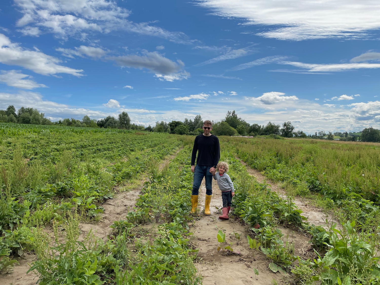 a man and child standing in a field