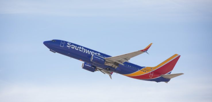 a blue and red airplane in the sky