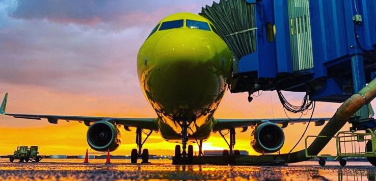 a yellow airplane on a runway