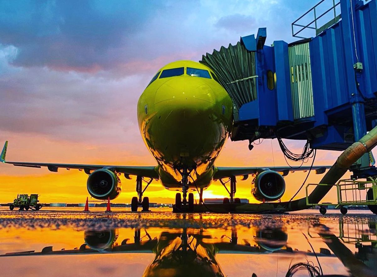 a yellow airplane on a runway