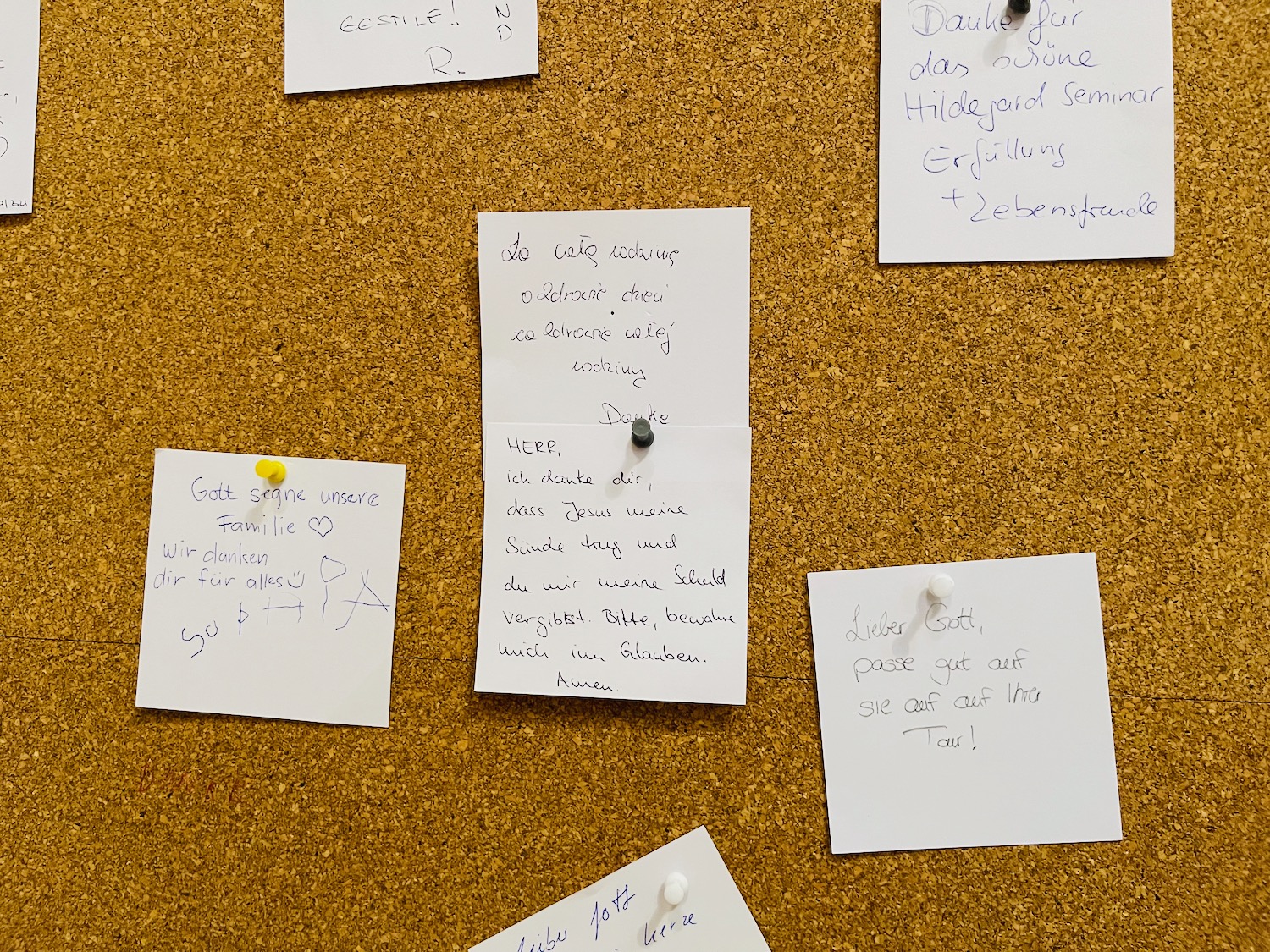 a cork board with notes pinned to it