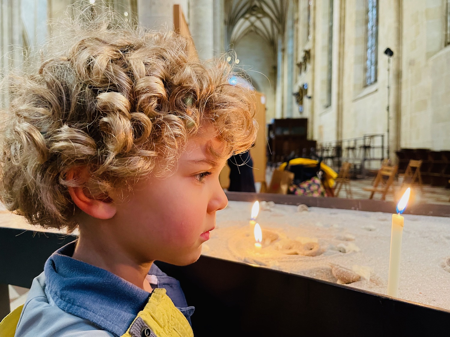 a boy looking at a candle