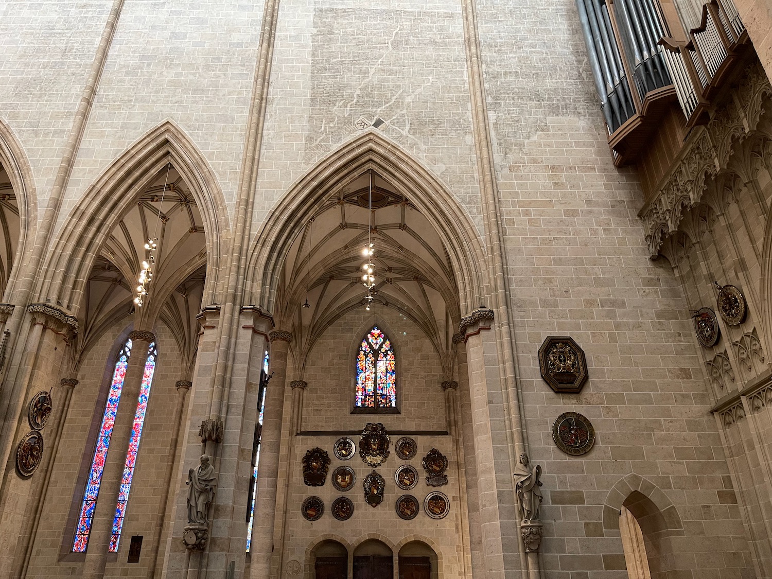 a large stone building with arches and stained glass windows