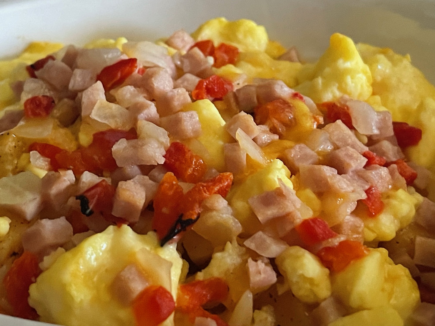 a bowl of scrambled eggs and ham