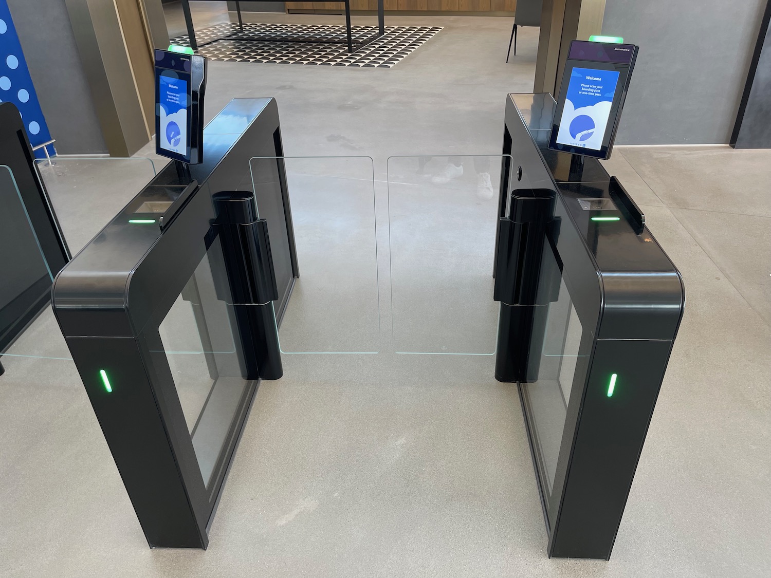 a two black turnstiles with a green light