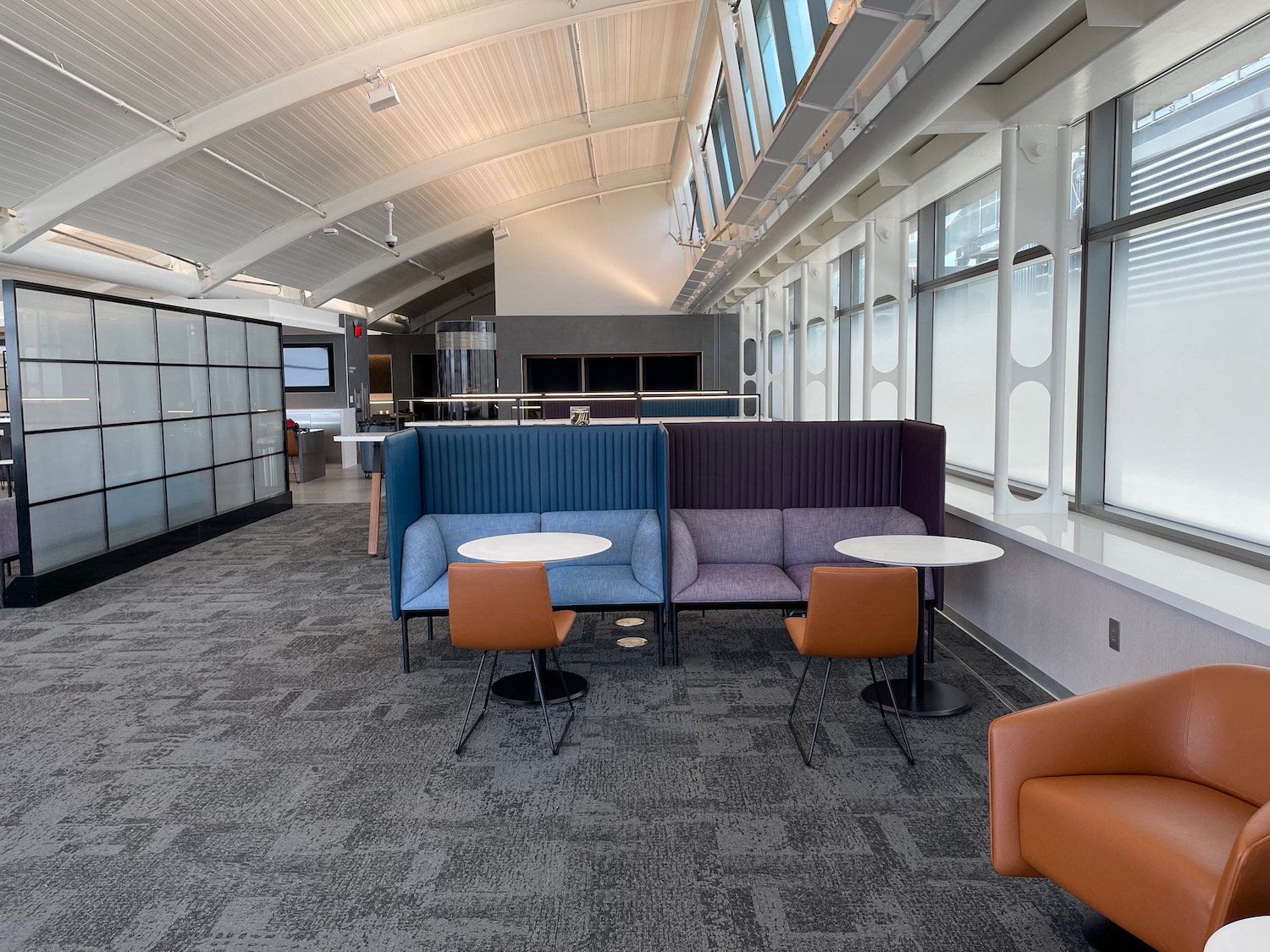 a room with a group of tables and chairs