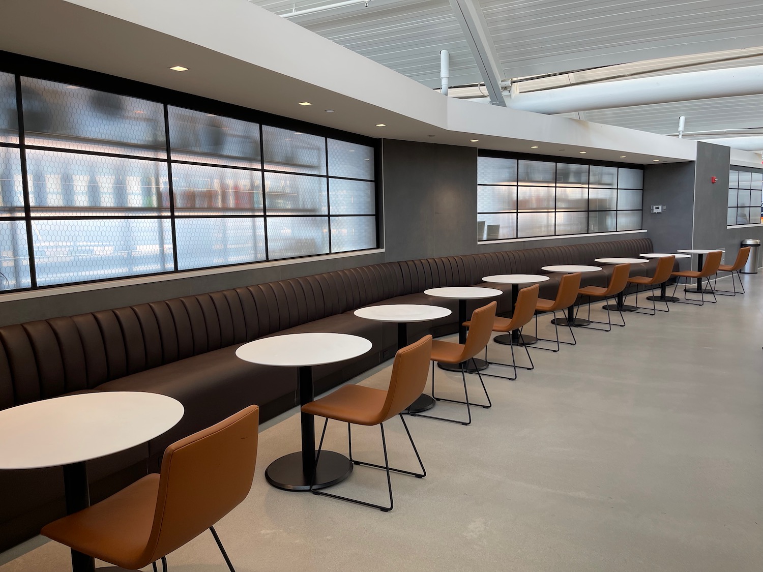 a long booth with tables and chairs