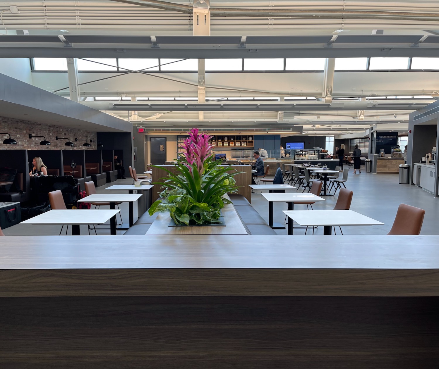 a room with tables and chairs and people