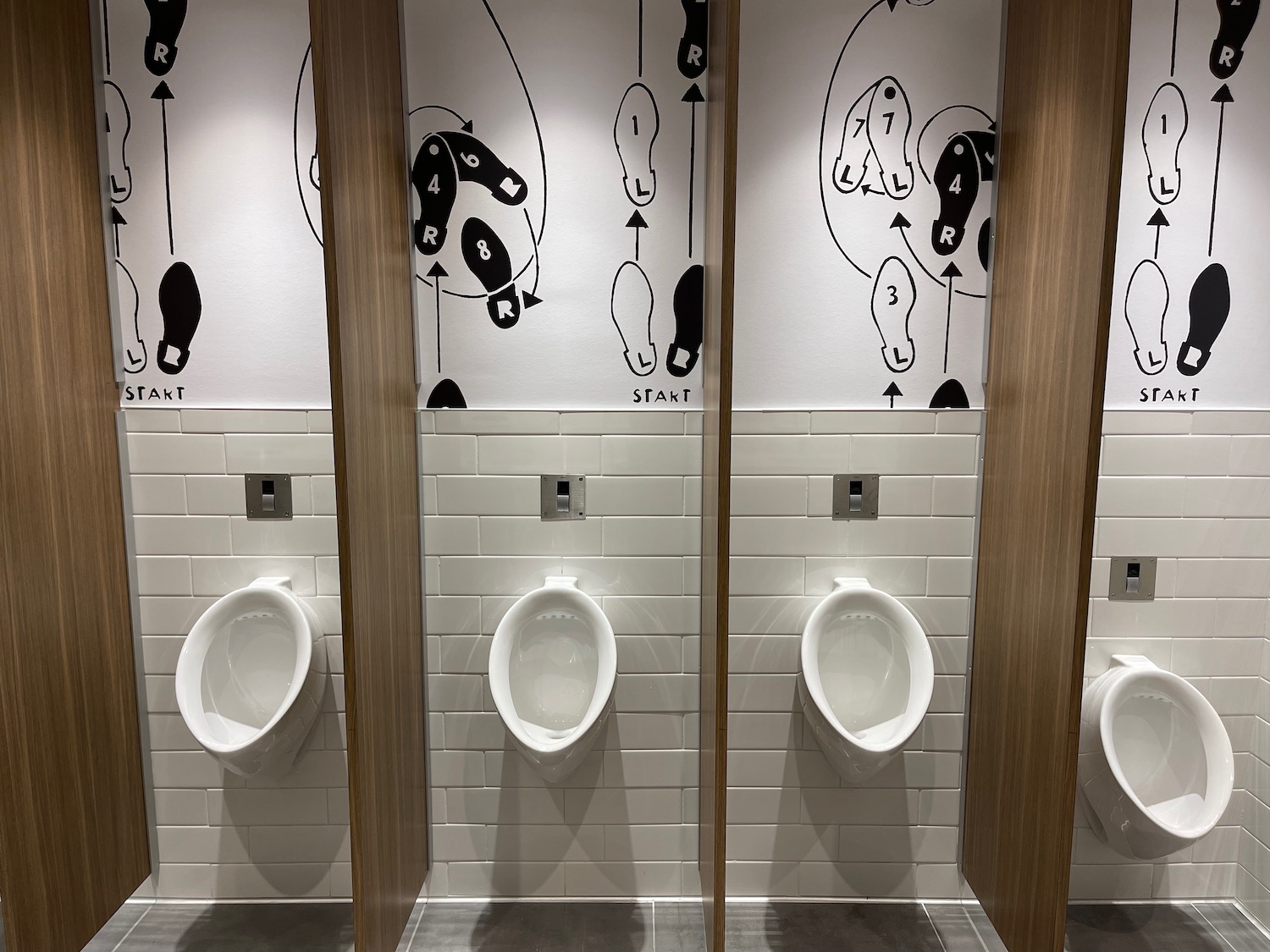 a row of urinals in a public bathroom