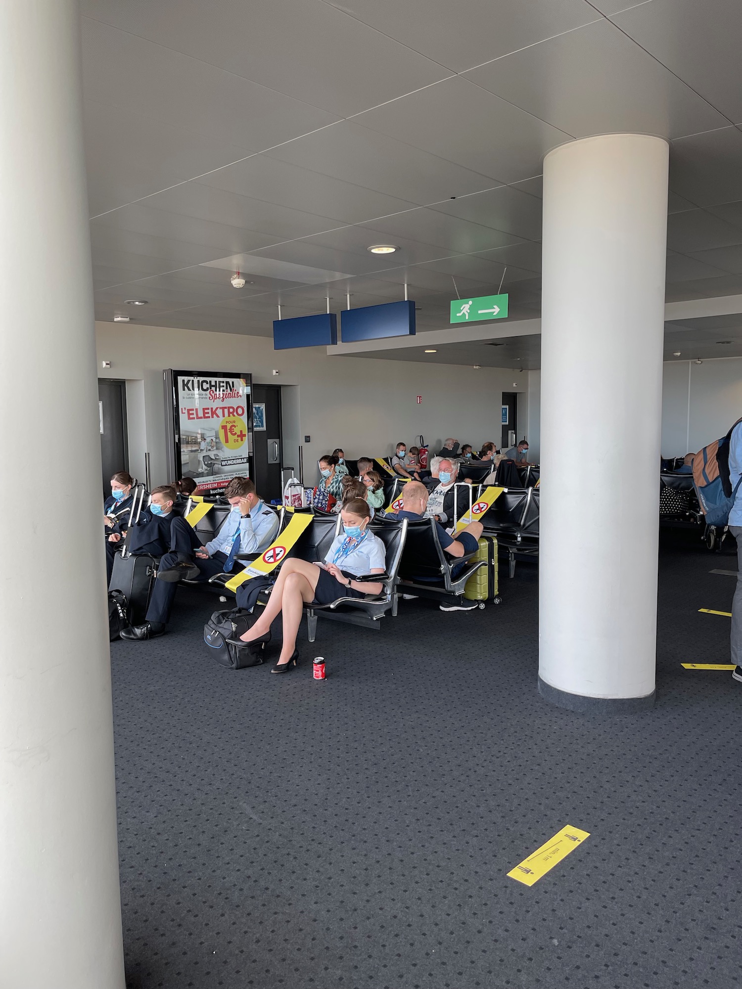 a group of people sitting in chairs in an airport