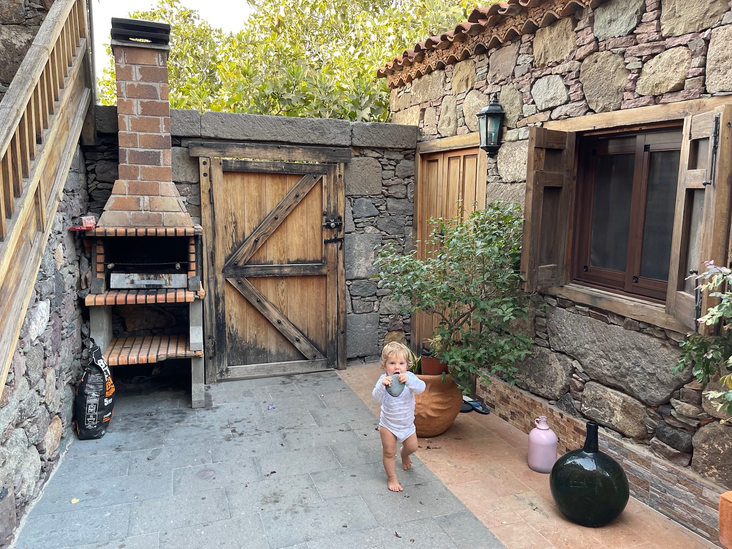 a baby walking in a courtyard