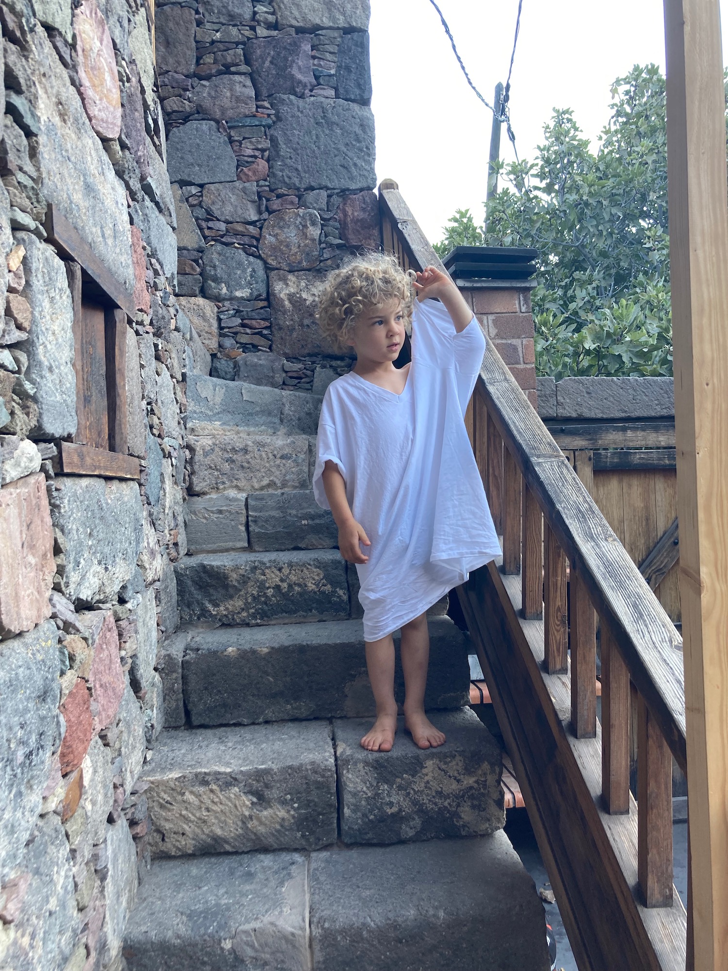 a child standing on a stone staircase