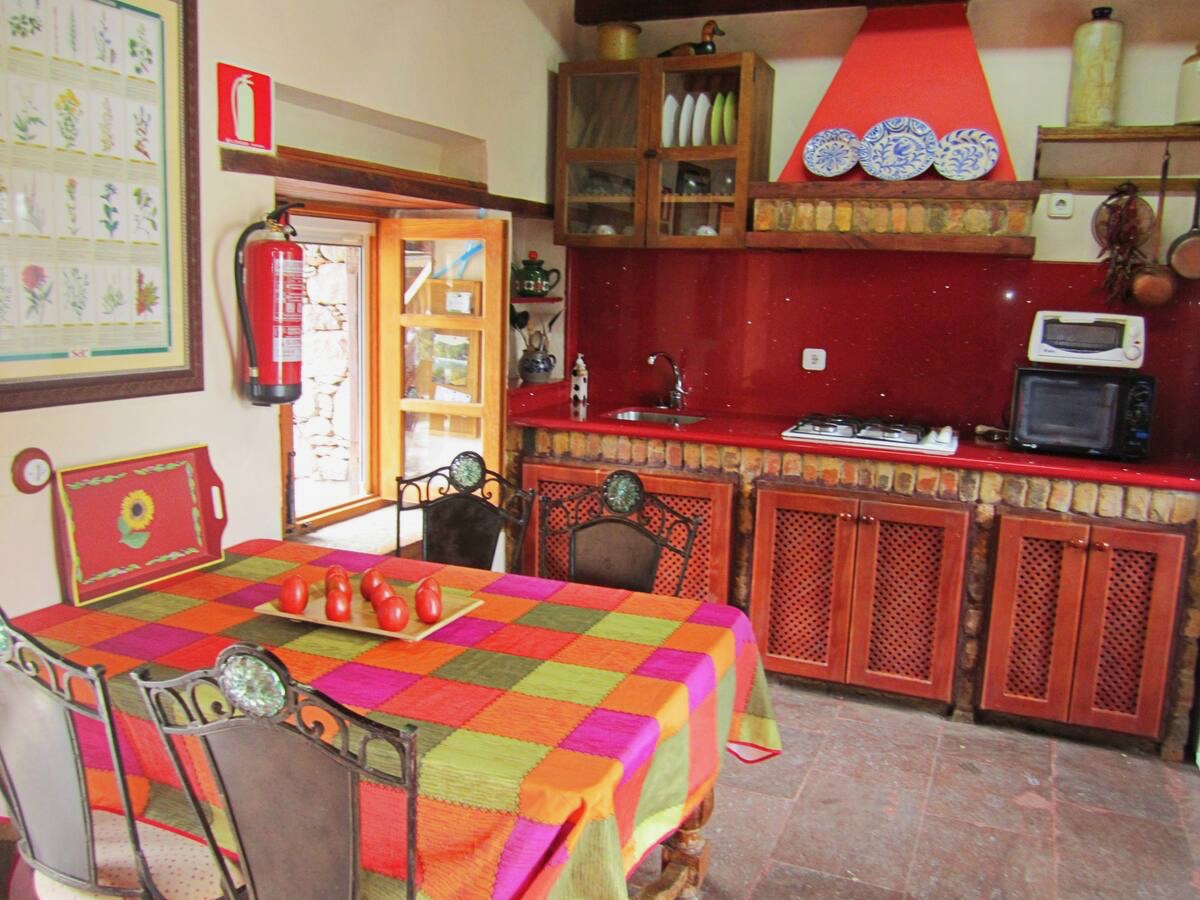 a kitchen with a table and chairs