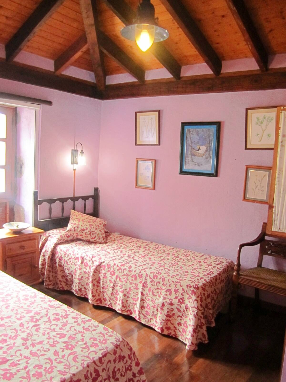 a room with pink walls and a bed