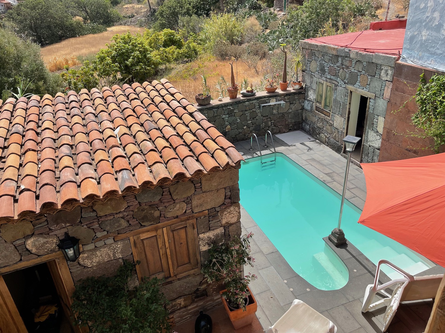 a pool and a building with a red roof