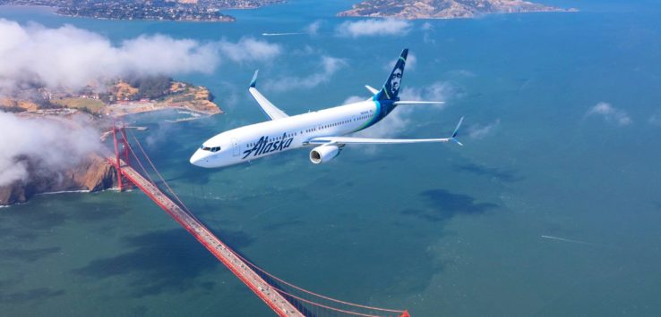 an airplane flying over a bridge