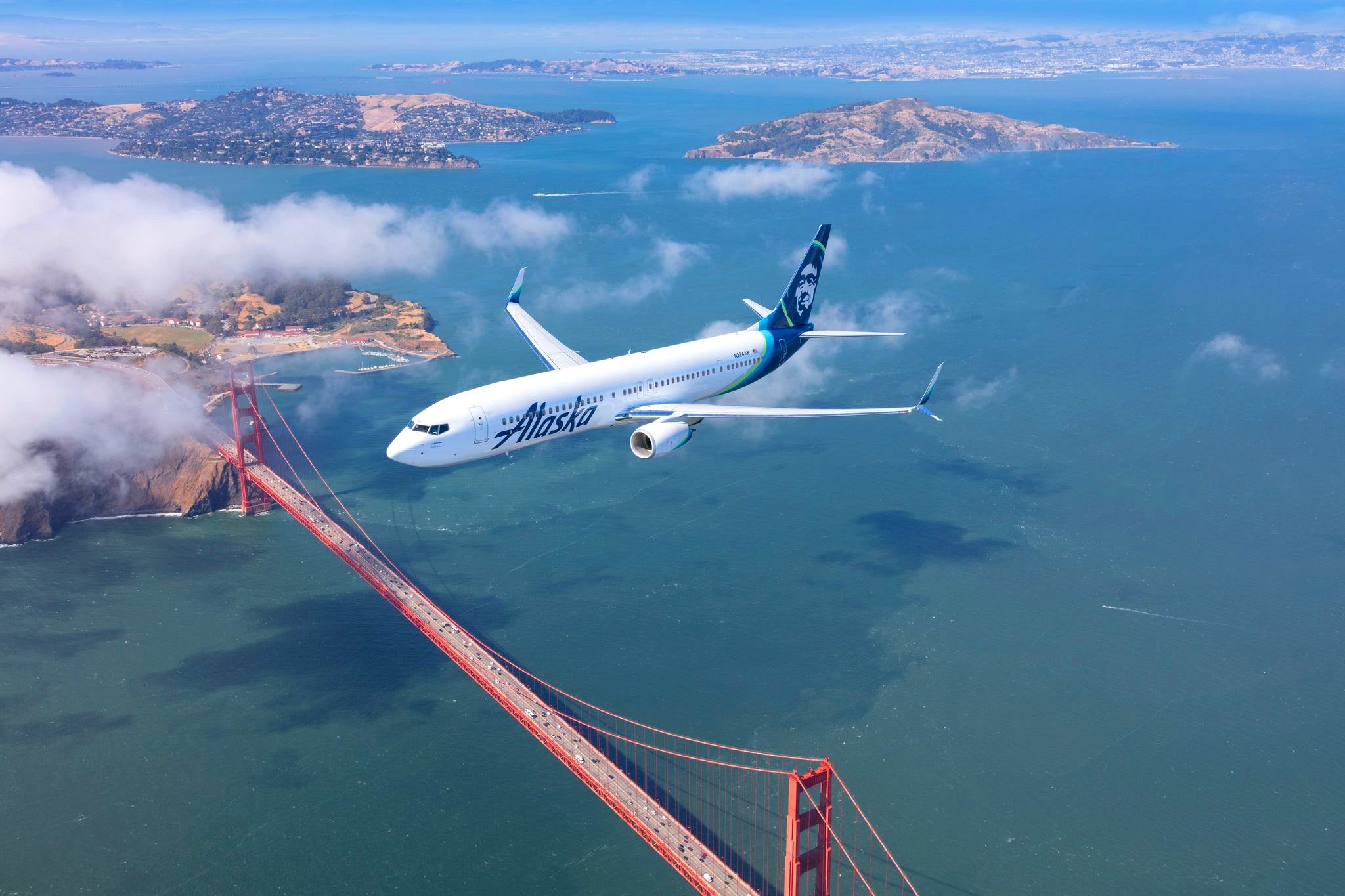 an airplane flying over a bridge